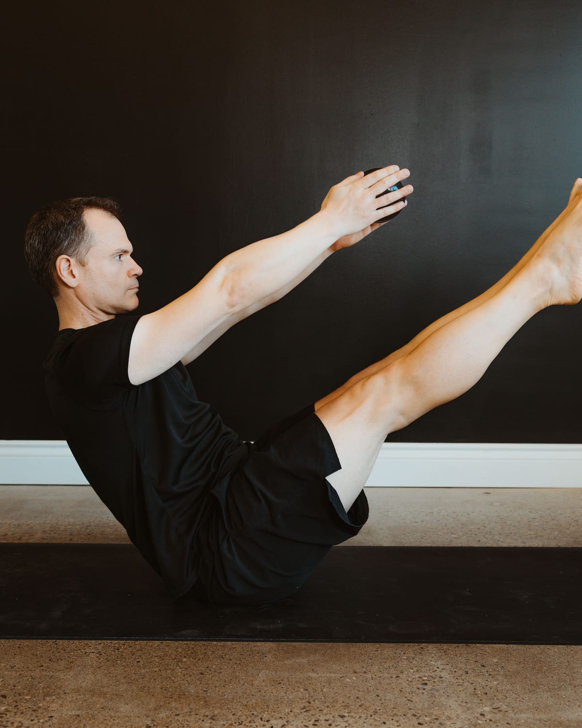 A teacher in boat pose