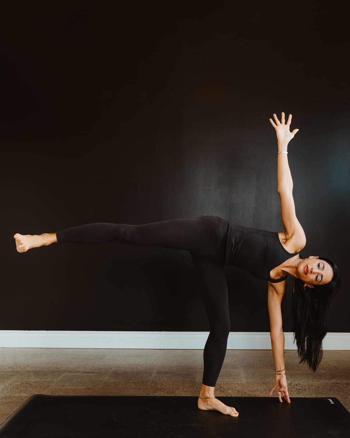 A teacher balancing in half moon pose