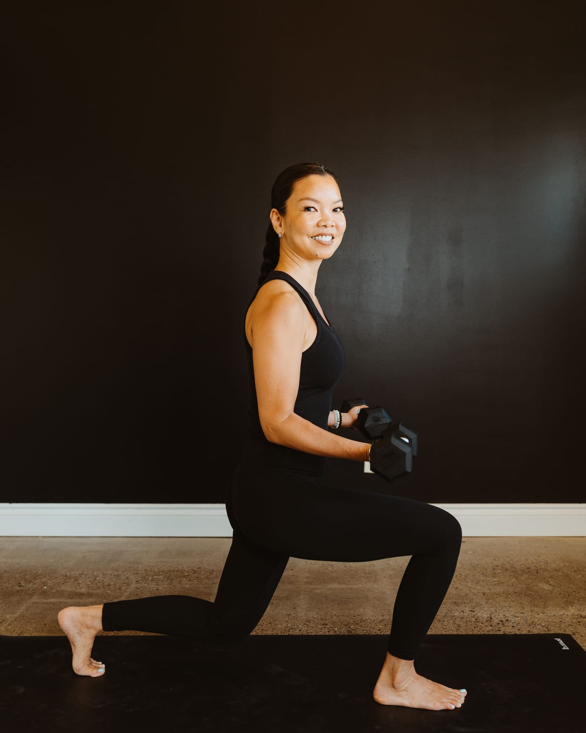 A teacher in a weighted lunge