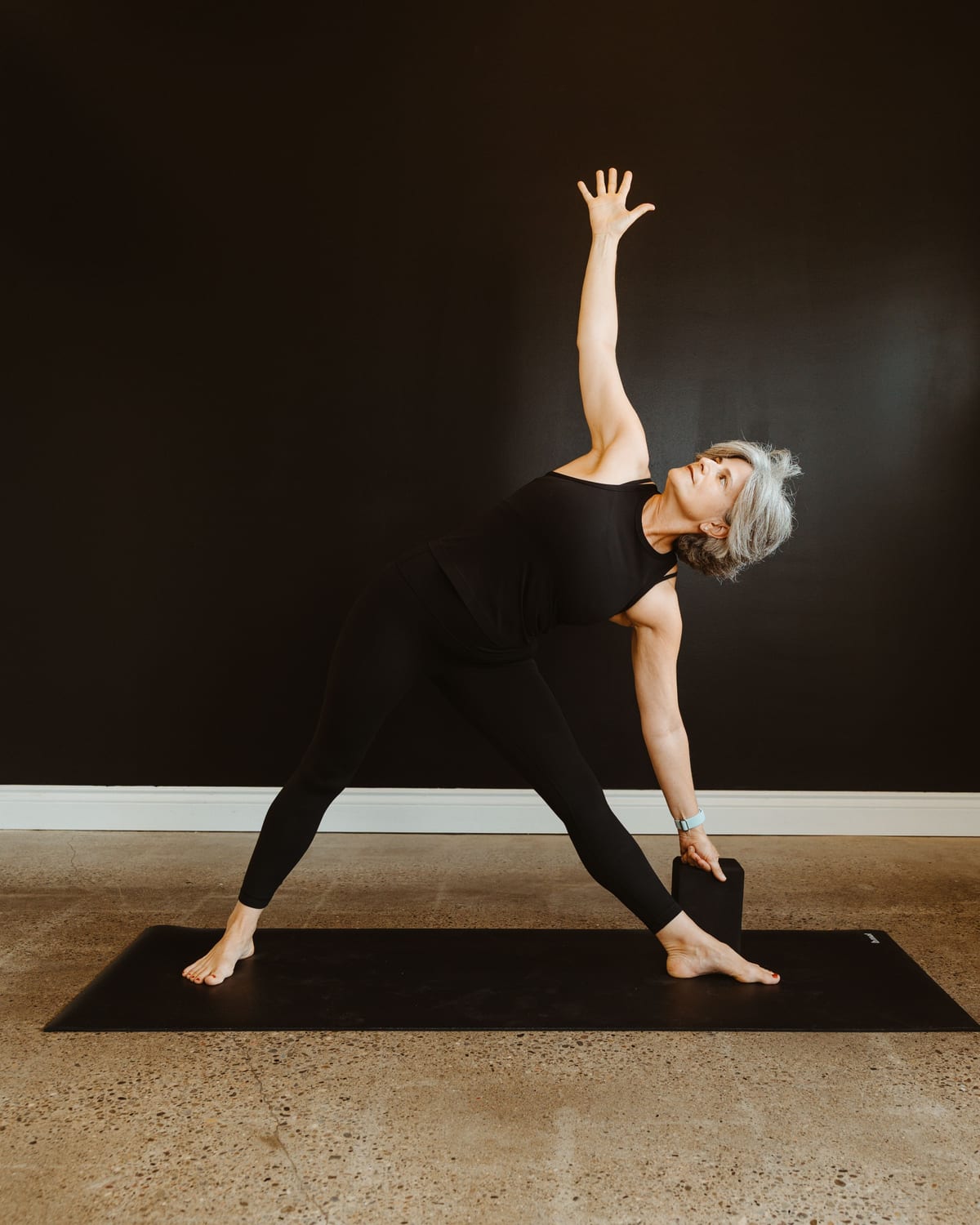A teacher in extended triangle pose