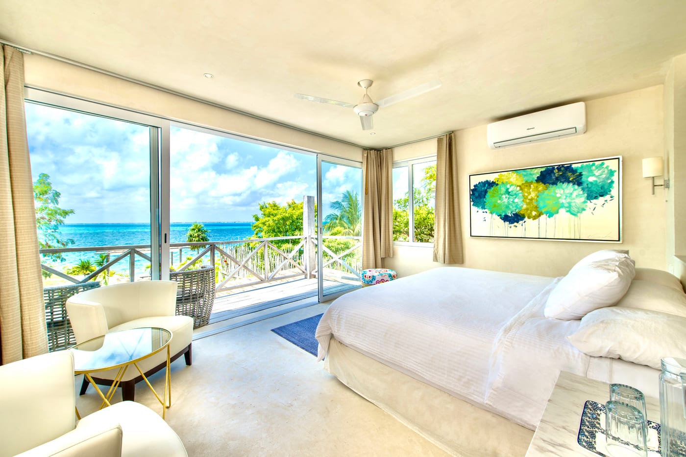 Bedroom with ocean view through floor-to-ceiling glass doors