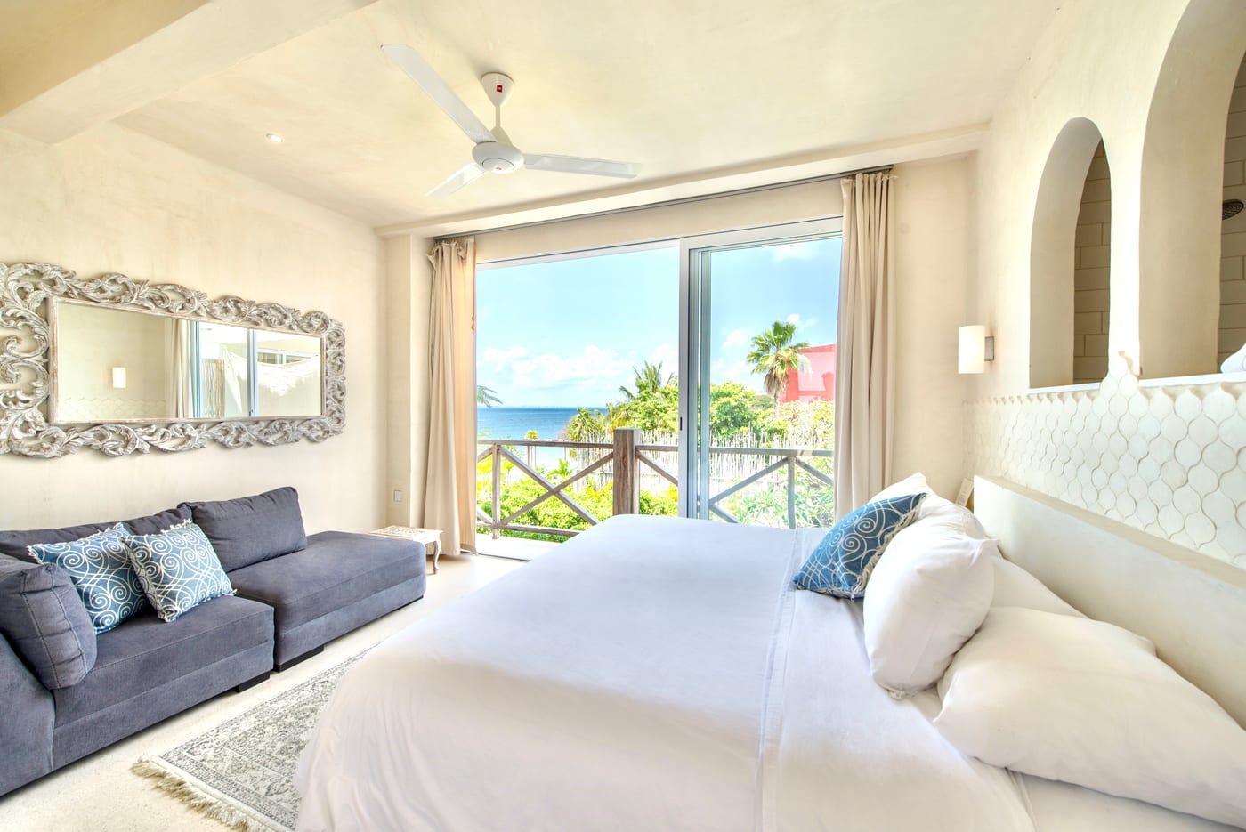 Bedroom with ocean view through private railed balcony