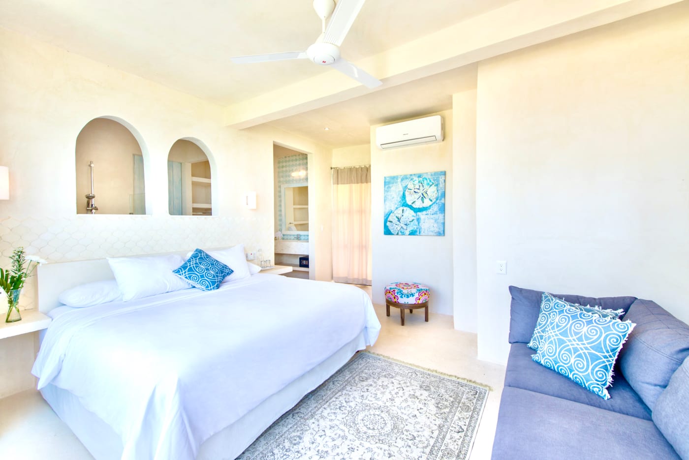 Styled guest bedroom with arched niches and decorative art