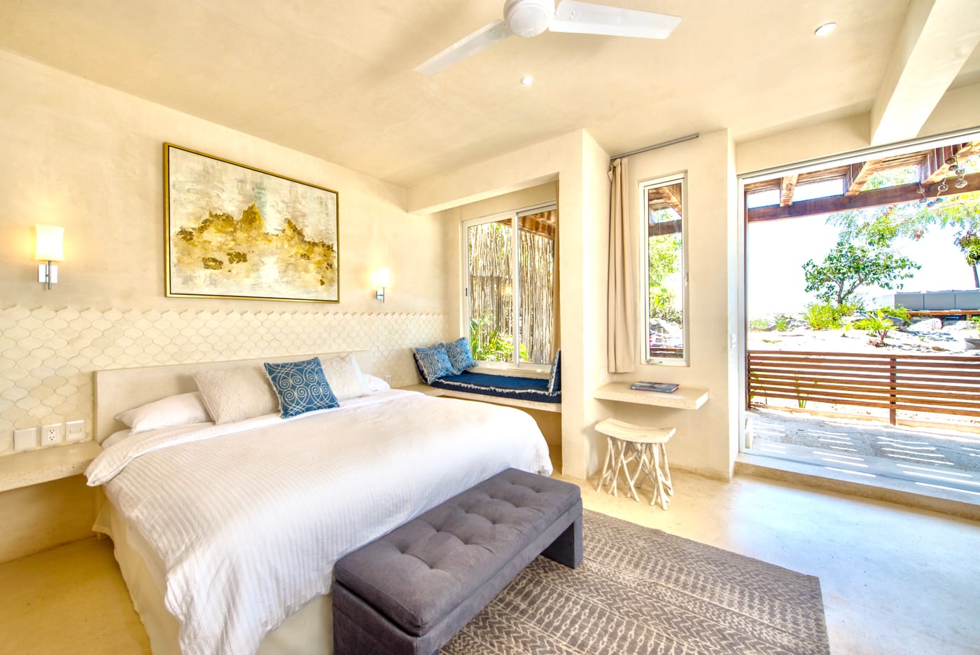 Bright guest room with window bench and terrace view
