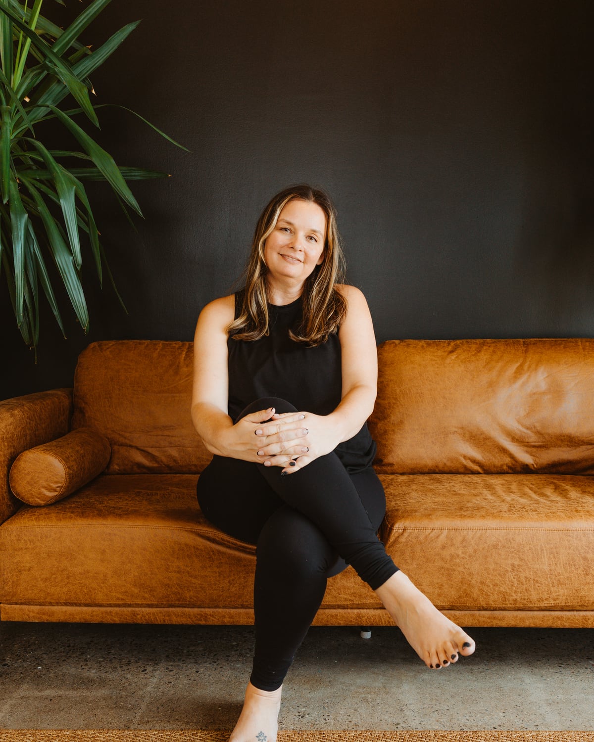 A Lineage teacher seated on the studio couch