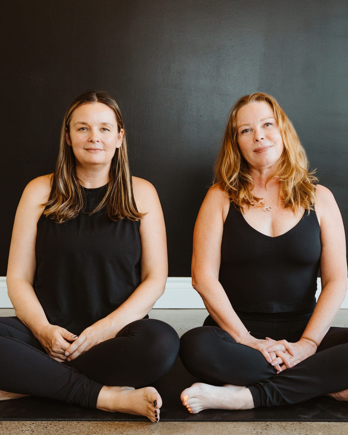 Two members seated together on their mats